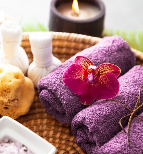 Spa and wellness. Natural bath salt and towels with orchid flower. Spa treatment