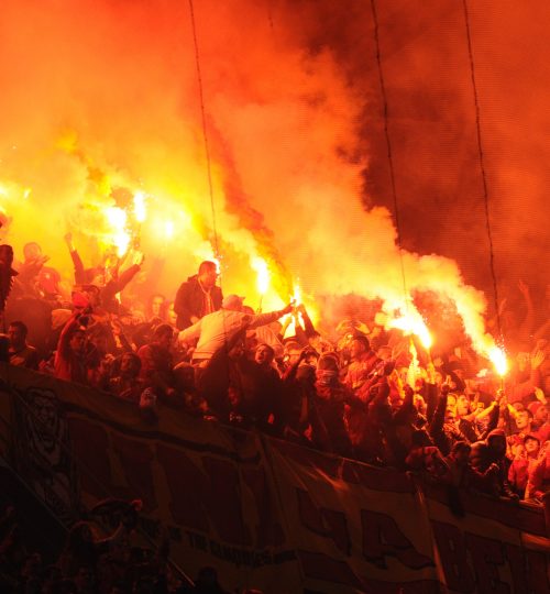 Galatasaray's supporters light flares during the UEFA Champions League quarter-final first leg football match Real Madrid vs Galatasaray on April 3,2013 at the Santiago Bernabeu stadium in Madrid.  AFP PHOTO / CURTO DE LA TORRE        (Photo credit should read CURTO DE LA TORRE/AFP/Getty Images)