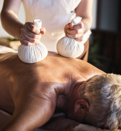Massage therapist massaging at a spa
