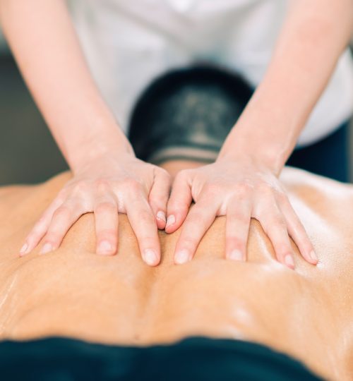 Sports massage. Therapist massaging sportsman's back