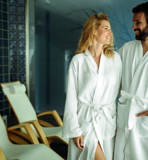 Beautiful couple relaxing in spa center