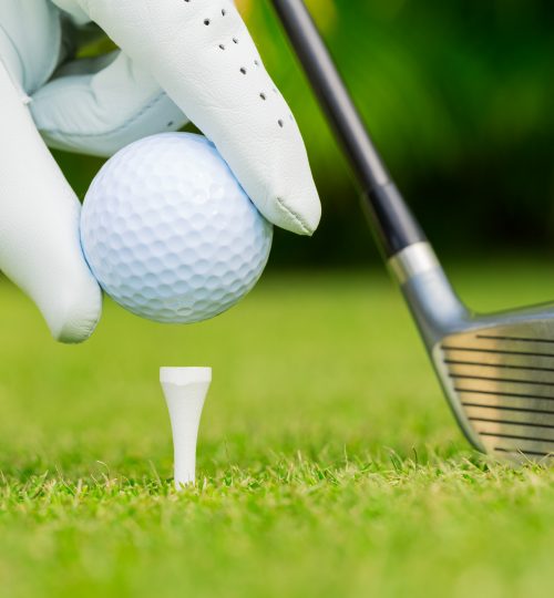 Close up view of golf ball on tee on golf course